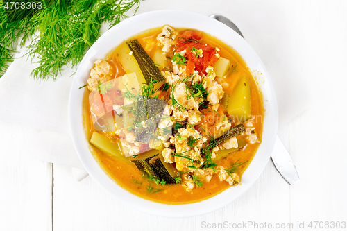 Image of Ragout of zucchini and minced meat in plate on board top