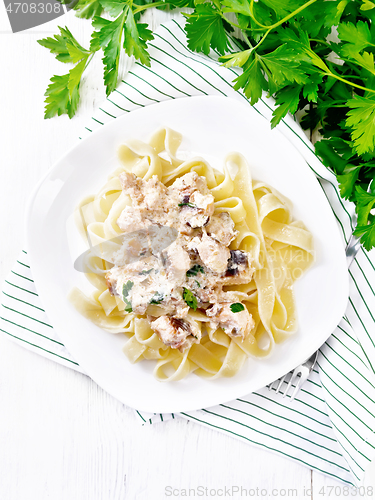 Image of Pasta with salmon in cream on white board top