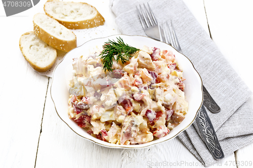 Image of Salad with chicken and vegetables in plate on board