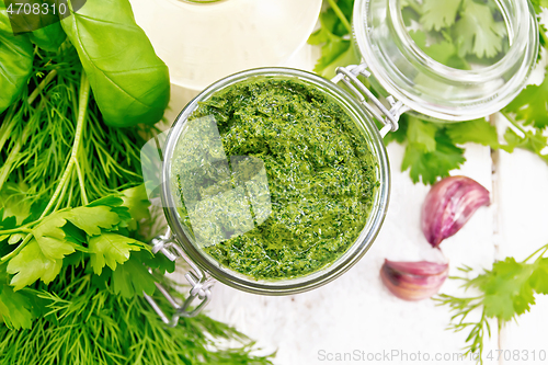 Image of Sauce of spicy greens in jar on light board top