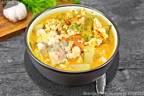 Image of Ragout of zucchini and minced meat in bowl on black board