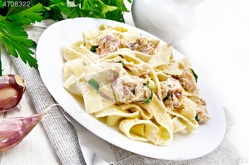 Image of Pasta with salmon and cream on light board