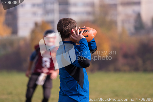 Image of american football team with coach in action