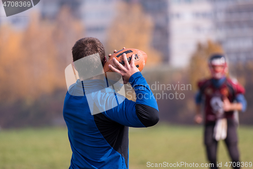 Image of american football team with coach in action