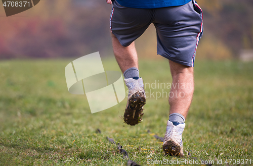 Image of american football player exercises on ladder drills