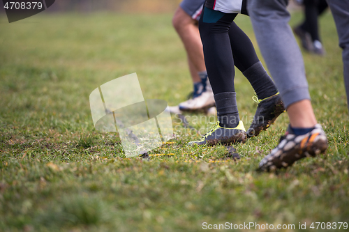 Image of american football team exercises on ladder drills