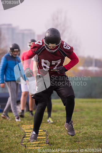 Image of American football team exercises on ladder drills at field