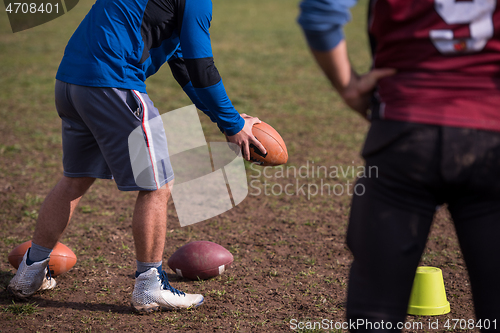 Image of american football team with coach in action