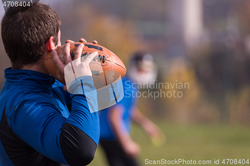 Image of american football team with coach in action