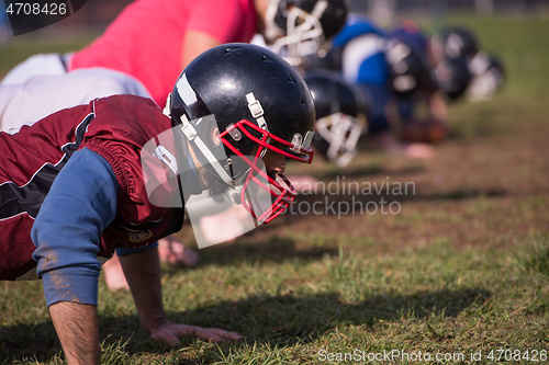 Image of american football team doing push ups