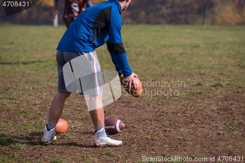 Image of american football kicker practicing kickoff