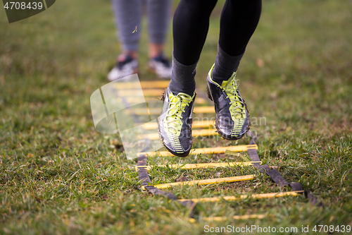 Image of american football player exercises on ladder drills