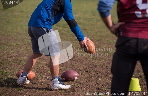 Image of american football team with coach in action