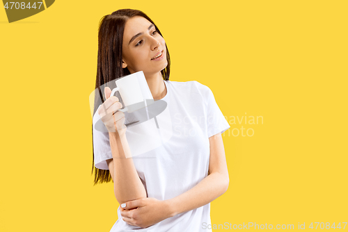 Image of Portrait of beautiful woman isolated on yellow studio background