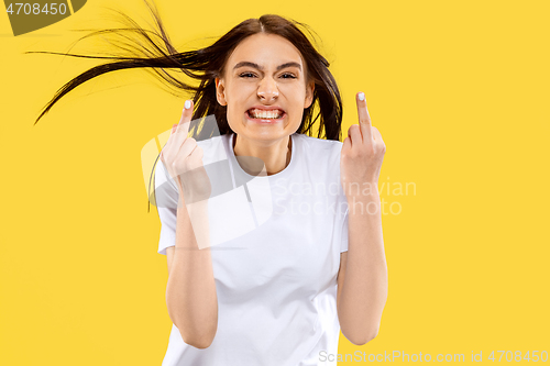 Image of Portrait of beautiful woman isolated on yellow studio background