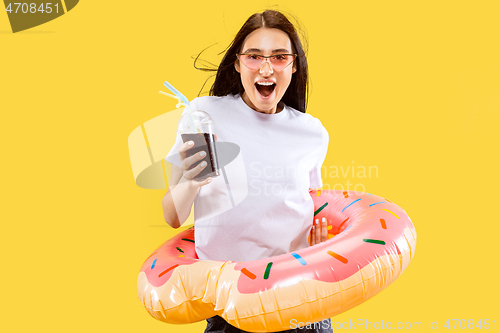 Image of Portrait of beautiful woman isolated on yellow studio background