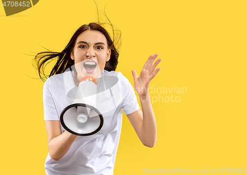 Image of Portrait of beautiful woman isolated on yellow studio background