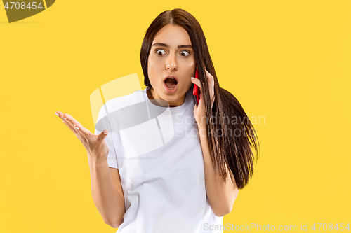 Image of Portrait of beautiful woman isolated on yellow studio background