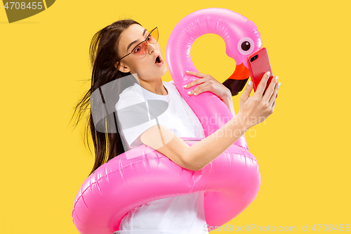 Image of Portrait of beautiful woman isolated on yellow studio background