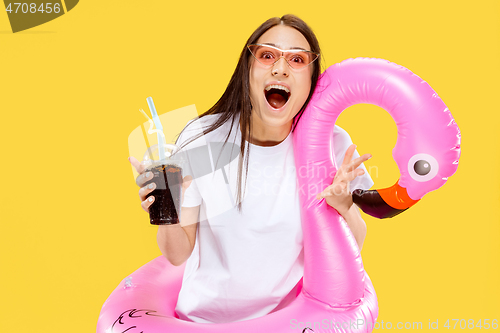 Image of Portrait of beautiful woman isolated on yellow studio background