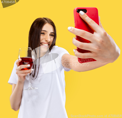 Image of Portrait of beautiful woman isolated on yellow studio background