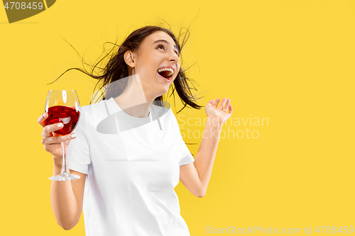 Image of Portrait of beautiful woman isolated on yellow studio background