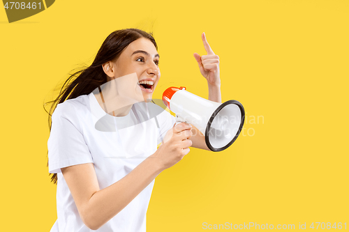 Image of Portrait of beautiful woman isolated on yellow studio background