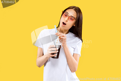 Image of Portrait of beautiful woman isolated on yellow studio background