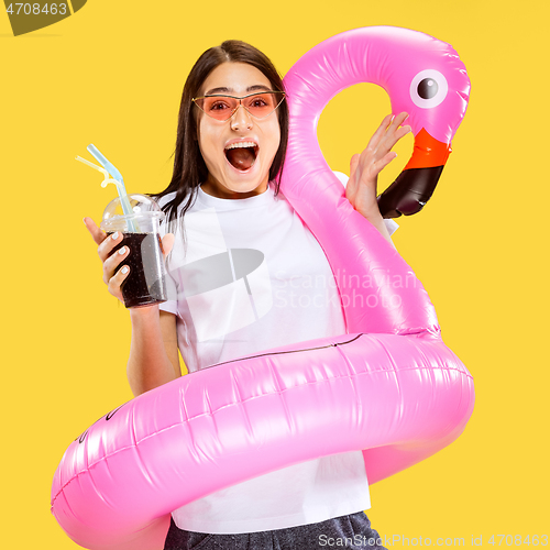 Image of Portrait of beautiful woman isolated on yellow studio background