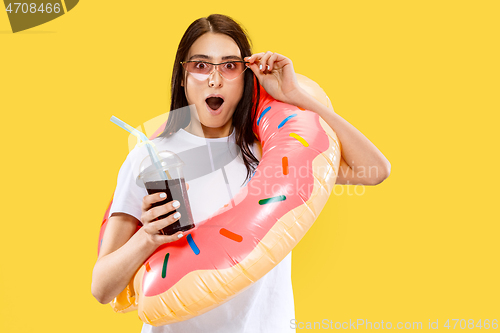 Image of Portrait of beautiful woman isolated on yellow studio background