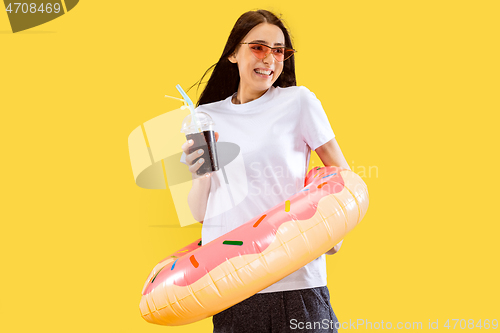 Image of Portrait of beautiful woman isolated on yellow studio background