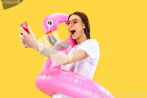 Image of Portrait of beautiful woman isolated on yellow studio background