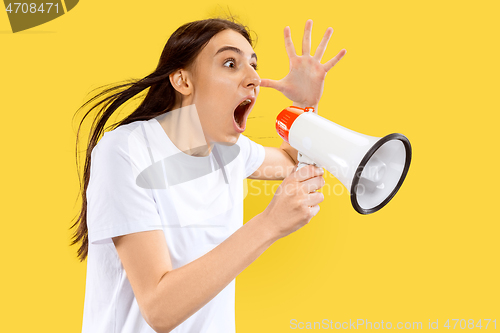 Image of Portrait of beautiful woman isolated on yellow studio background