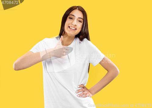 Image of Portrait of beautiful woman isolated on yellow studio background