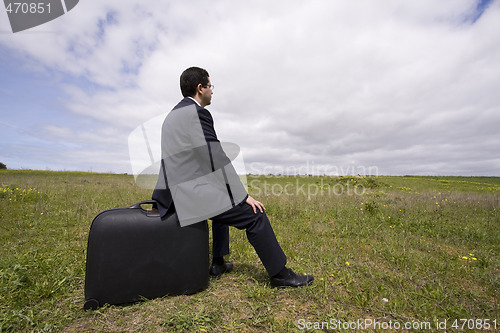 Image of businessman sit in his baggage 