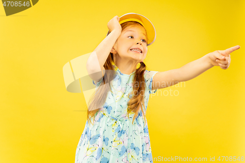 Image of Beautiful emotional little girl isolated on yellow background