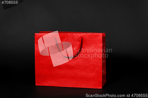 Image of red shopping bag on black background