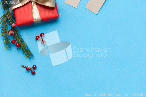 Image of christmas gift and fir branches with berries