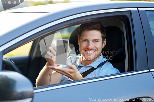 Image of man or car driver showing smartphone