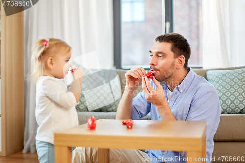 Image of father and daughter playing tea party at home