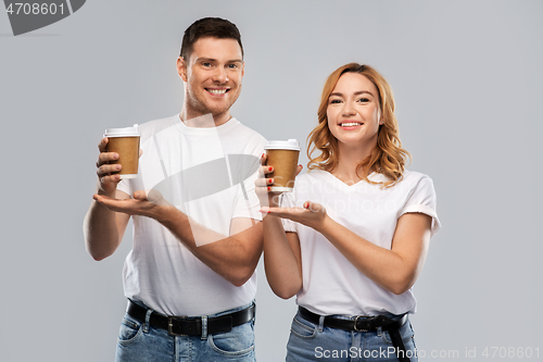 Image of portrait of happy couple with takeaway coffee cups