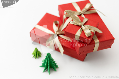 Image of gift boxes and christmas trees on white background