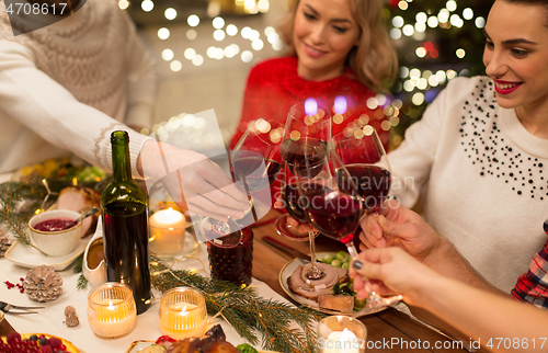 Image of close up of friends with wine celebrate christmas