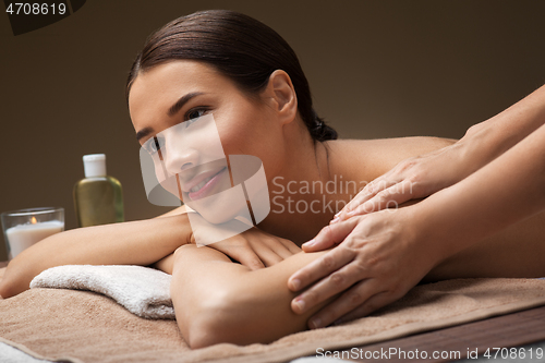 Image of woman lying and having massage at spa