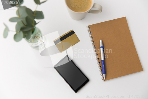 Image of smartphone, credit card, notebook and coffee