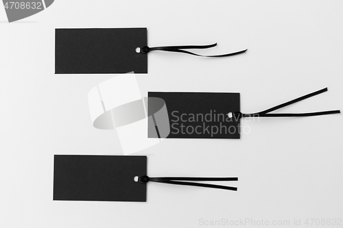 Image of three black tags on white background