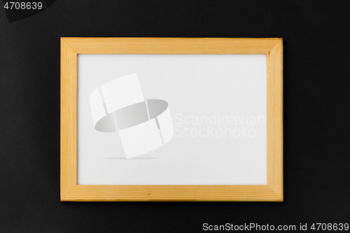 Image of white board in wooden frame on black background