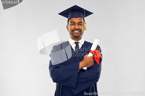 Image of male graduate student in mortar board with diploma