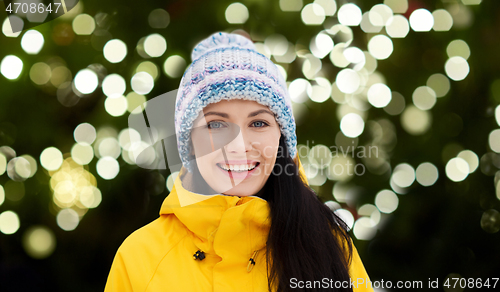 Image of happy young woman in winter clothes outdoors