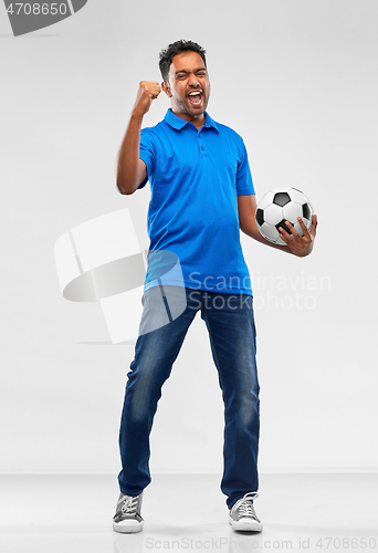 Image of football fan with soccer ball celebrating victory